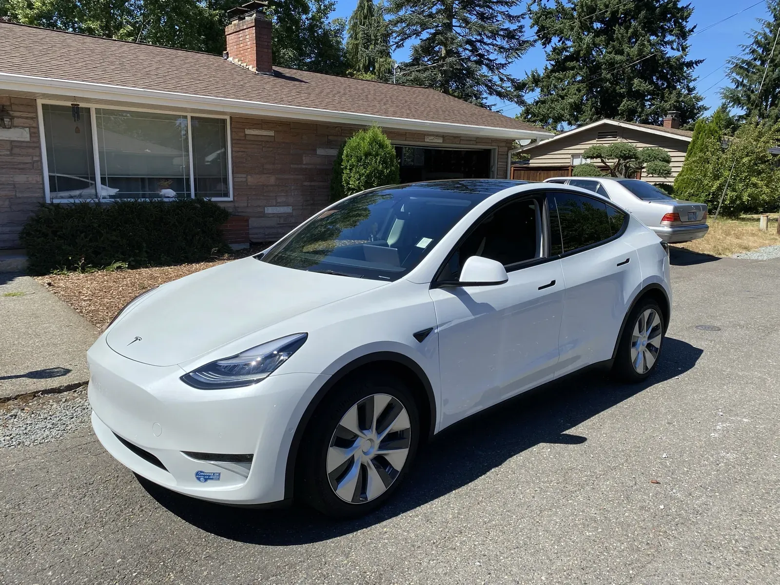 White Model Y parked in a driveway