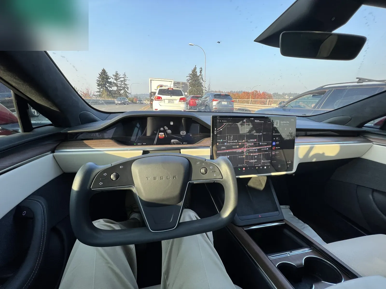 Model S Plaid interior with the yoke steering wheel in highway traffic